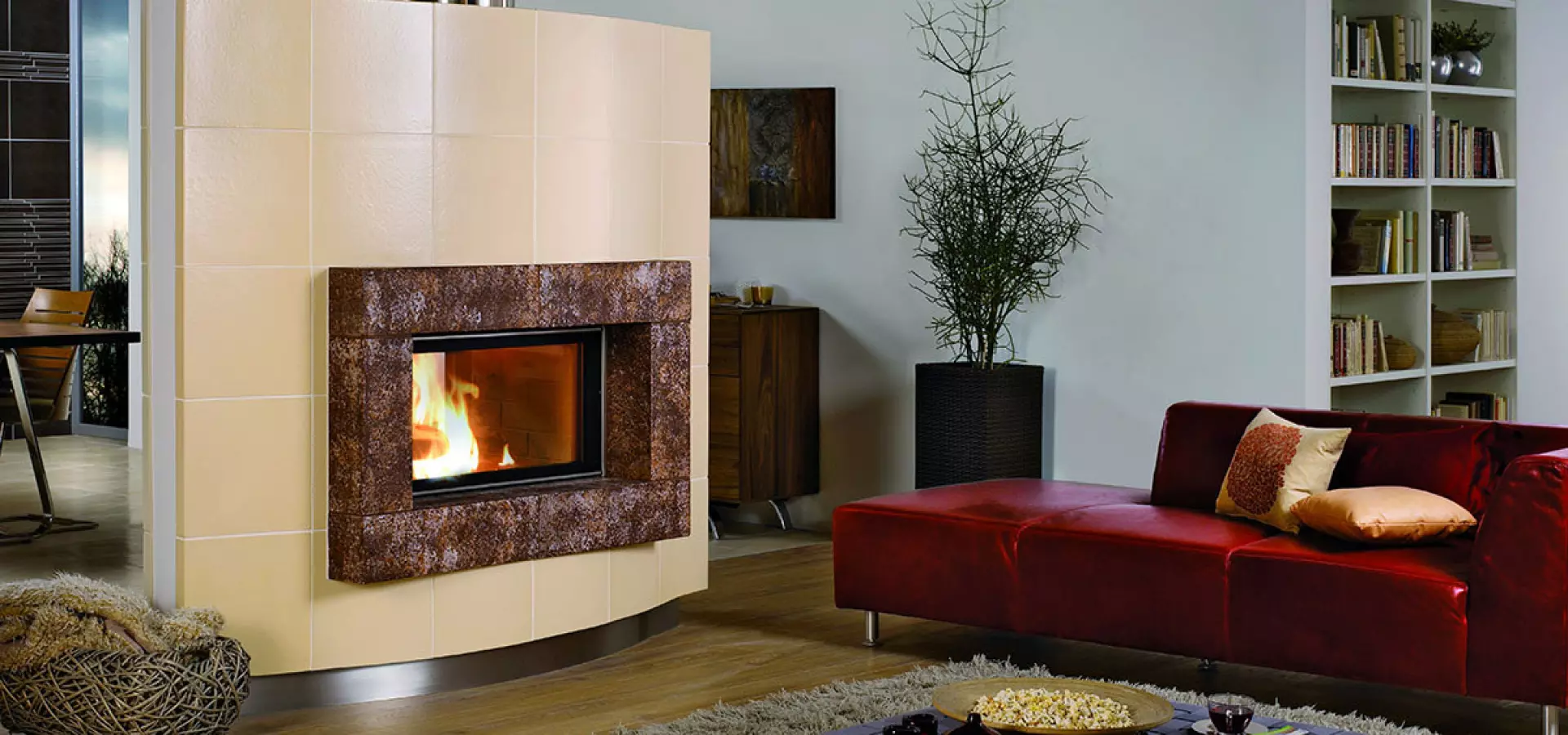 Design-Heizkamin mit keramischer Verkleidung – stilvolle Wärme für moderne Wohnräume. Moderner Heizkamin mit keramischer Verkleidung in hellem Wohnzimmer, rote Design-Couch im Vordergrund.
